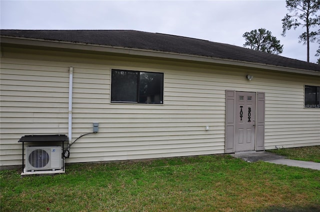 exterior space featuring ac unit and a lawn