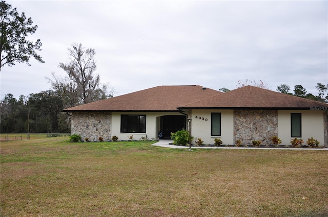 ranch-style house with a front lawn