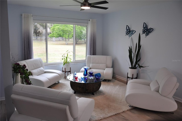 living room featuring ceiling fan and wood-type flooring