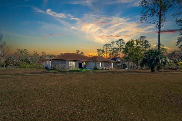 single story home featuring a yard