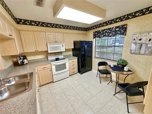 kitchen featuring light brown cabinetry, light tile patterned floors, white appliances, and sink