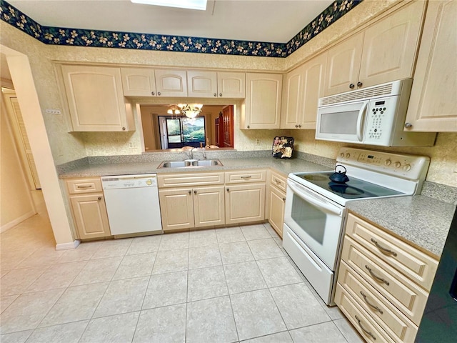 kitchen featuring light brown cabinets, sink, an inviting chandelier, white appliances, and light tile patterned floors