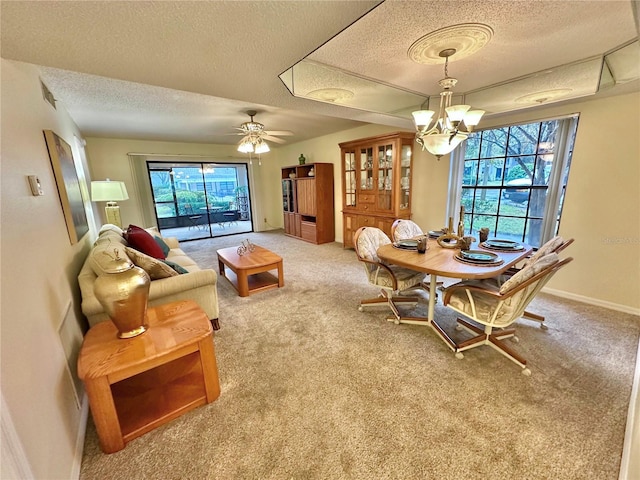 dining area featuring a wealth of natural light, carpet, and a textured ceiling