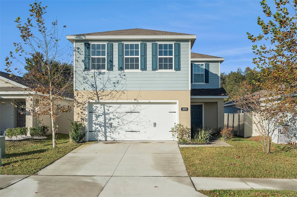 view of front facade featuring a front yard and a garage