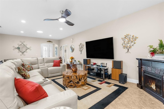 living room with ceiling fan and light tile patterned flooring