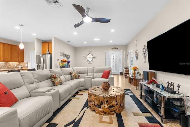 tiled living room featuring ceiling fan