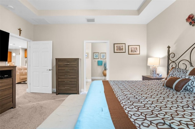 carpeted bedroom with ensuite bath