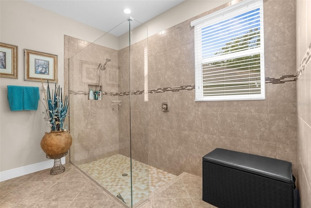 bathroom featuring a tile shower and tile patterned flooring