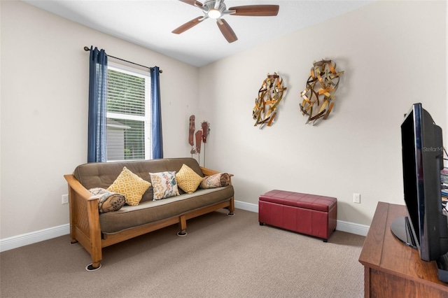 carpeted living room with ceiling fan