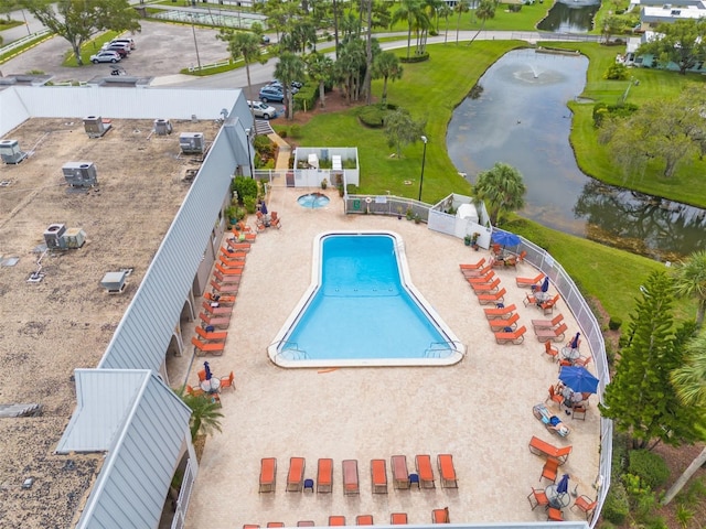 view of pool with a water view and central air condition unit