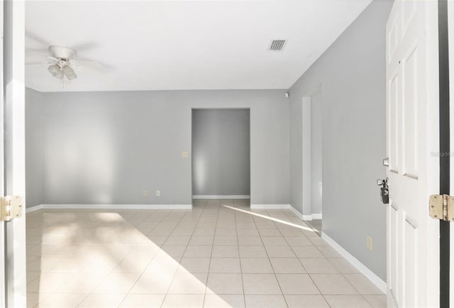 spare room with ceiling fan and light tile patterned floors