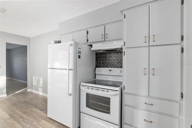 kitchen featuring white cabinets, light wood-type flooring, white appliances, and a textured ceiling