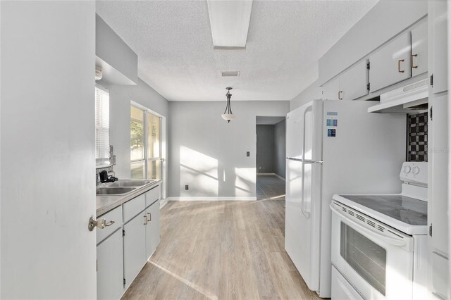 kitchen with white cabinets, white electric range, and hanging light fixtures