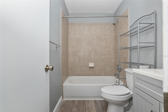 full bathroom featuring tiled shower / bath, toilet, vanity, and hardwood / wood-style flooring