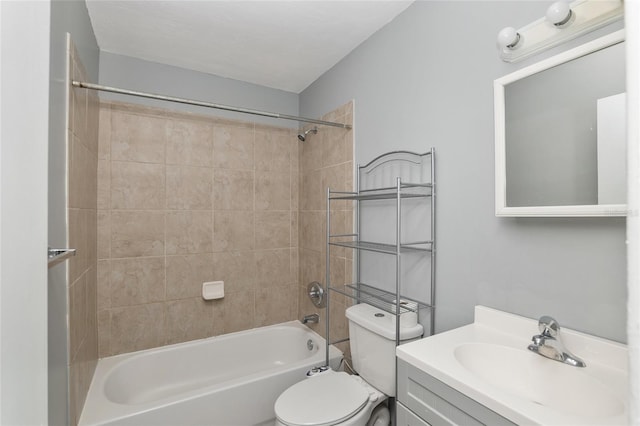 full bathroom featuring tiled shower / bath combo, toilet, and vanity