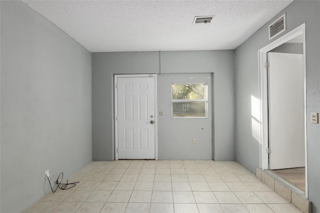 foyer featuring a textured ceiling