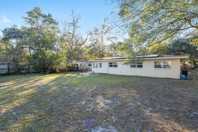 rear view of house featuring a lawn