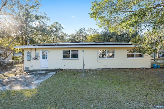 rear view of house with a patio area and a yard