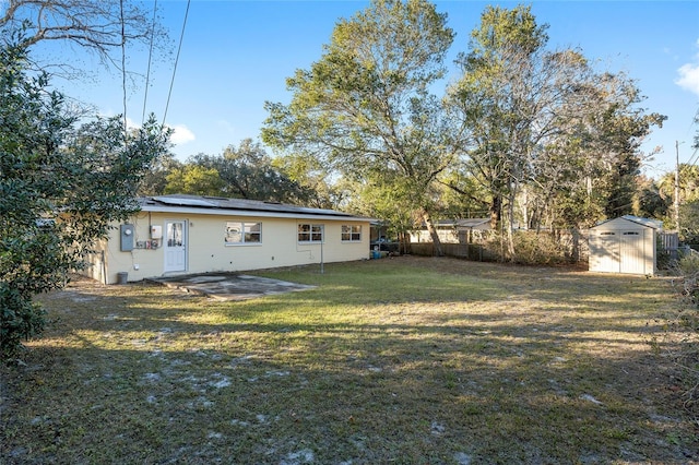 view of yard featuring a patio and a storage shed