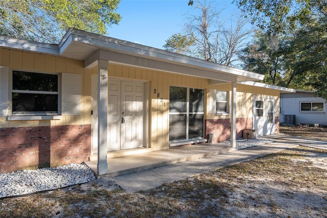 doorway to property with central air condition unit