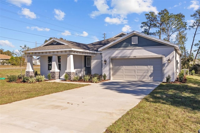 view of front of house with a porch, a garage, and a front lawn