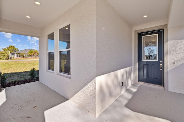 doorway to property featuring a lawn