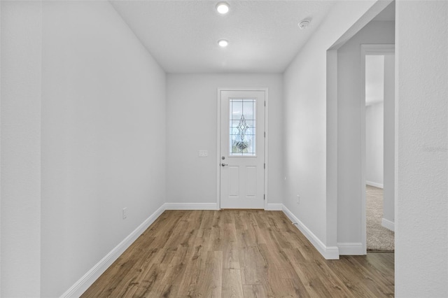 doorway with light wood-type flooring