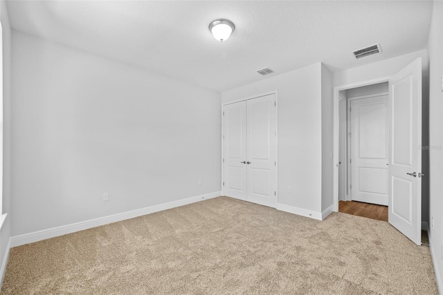 unfurnished bedroom featuring carpet floors and a closet