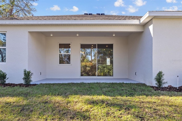 rear view of property with a lawn and a patio area