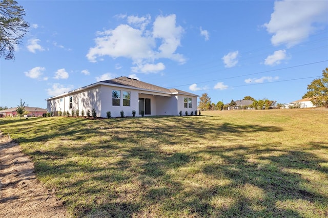 rear view of house featuring a yard