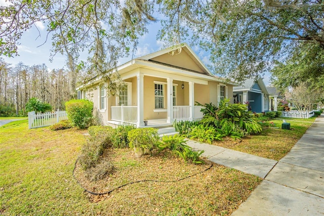 view of front of house featuring a front yard and covered porch