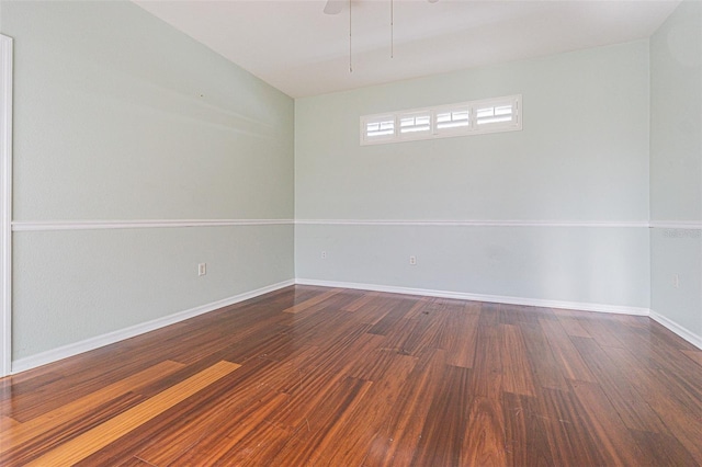 empty room with ceiling fan and dark hardwood / wood-style floors