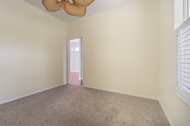 spare room with ceiling fan, a healthy amount of sunlight, and carpet floors