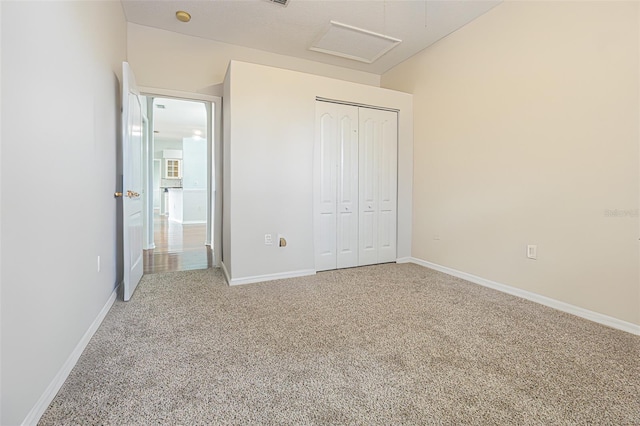 unfurnished bedroom with a closet and carpet flooring