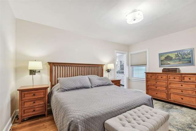 bedroom featuring baseboards and light wood finished floors