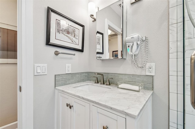 bathroom featuring tasteful backsplash and vanity