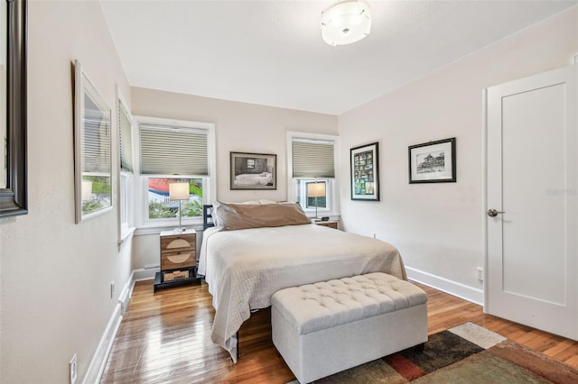 bedroom featuring baseboards and wood finished floors