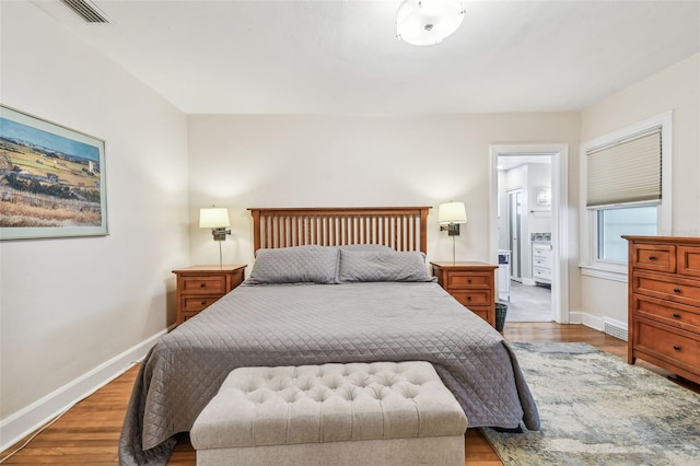 bedroom with baseboards, visible vents, and light wood-style floors