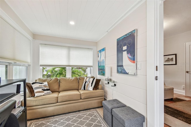 living area with wood finished floors and wood ceiling