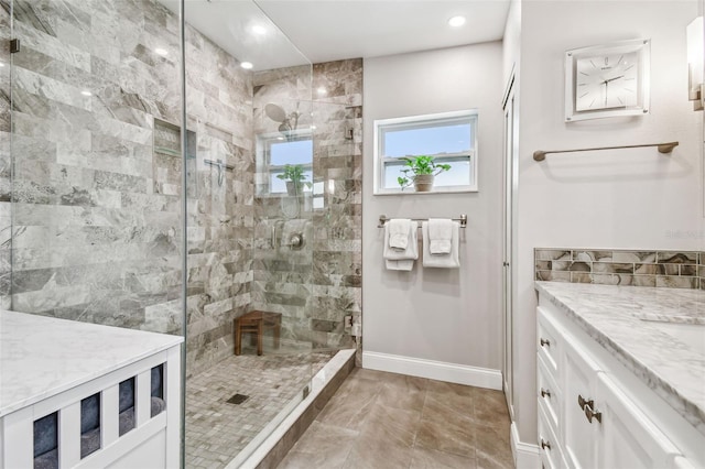 bathroom featuring a stall shower, vanity, baseboards, and recessed lighting