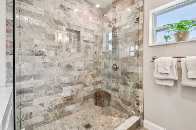 bathroom with baseboards and a tile shower