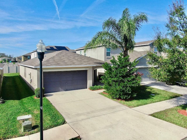 view of front of property with a garage and a front yard