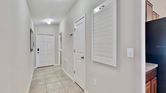 corridor with light tile patterned floors