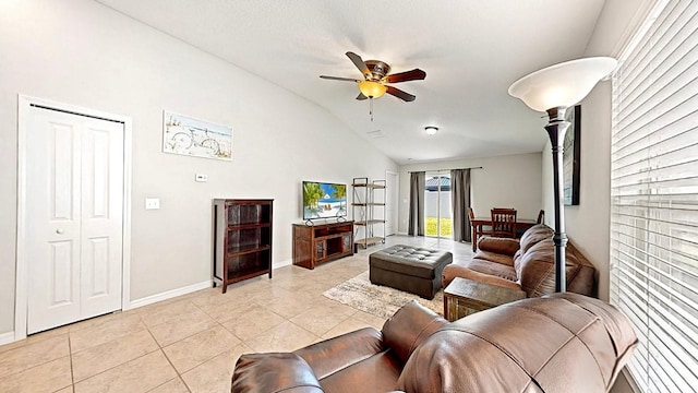 tiled living room with ceiling fan and lofted ceiling