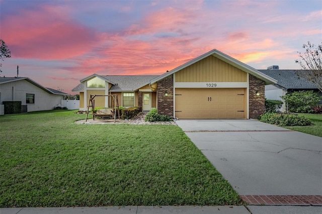 ranch-style house with a garage and a lawn