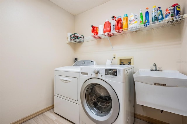 laundry area featuring sink and independent washer and dryer