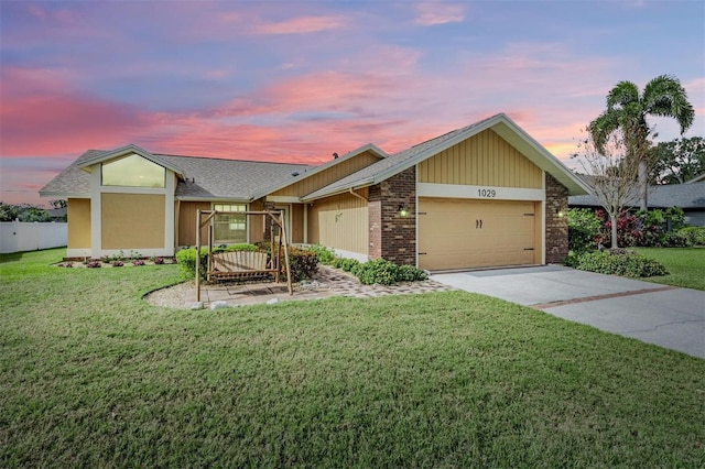 view of front of house with concrete driveway, brick siding, an attached garage, and a front yard