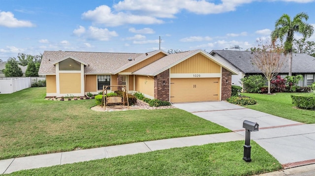 single story home featuring brick siding, concrete driveway, fence, a garage, and a front lawn