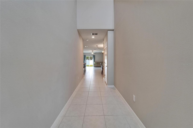 corridor featuring light tile patterned floors