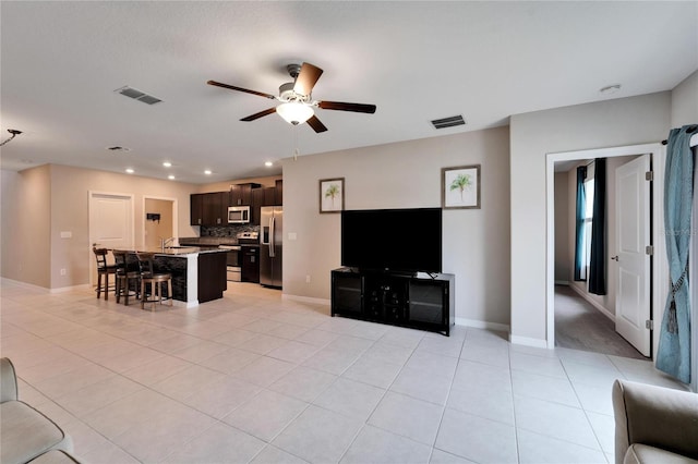 tiled living room featuring ceiling fan